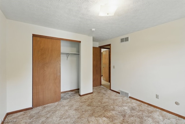 450 S Walnut St, Ravenna, OH 44266 - unfurnished bedroom with a closet, carpet, and a textured ceiling
