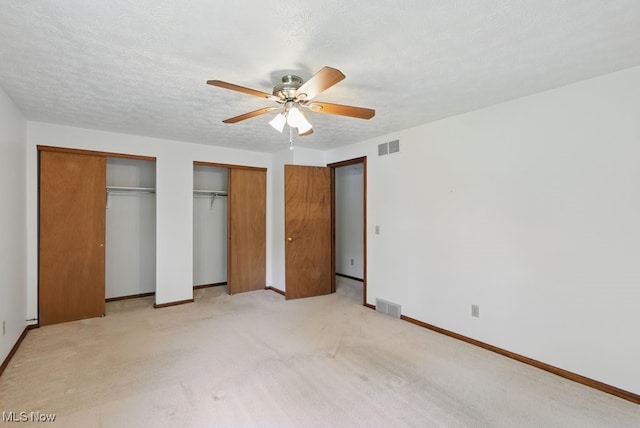 450 S Walnut St, Ravenna, OH 44266 - unfurnished bedroom featuring two closets, light colored carpet, and a ceiling fan