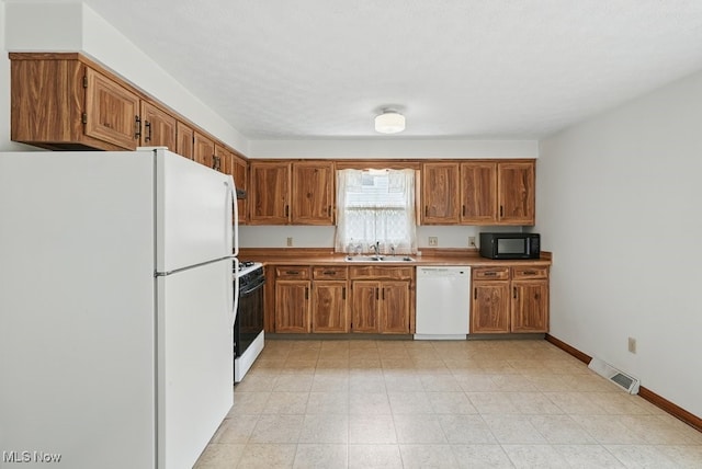 450 S Walnut St, Ravenna, OH 44266 - kitchen with white appliances, brown cabinets, and light countertops