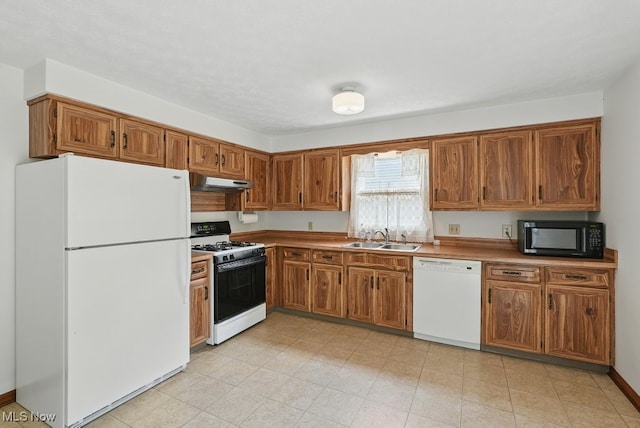 450 S Walnut St, Ravenna, OH 44266 - kitchen featuring white appliances, under cabinet range hood, and brown cabinets
