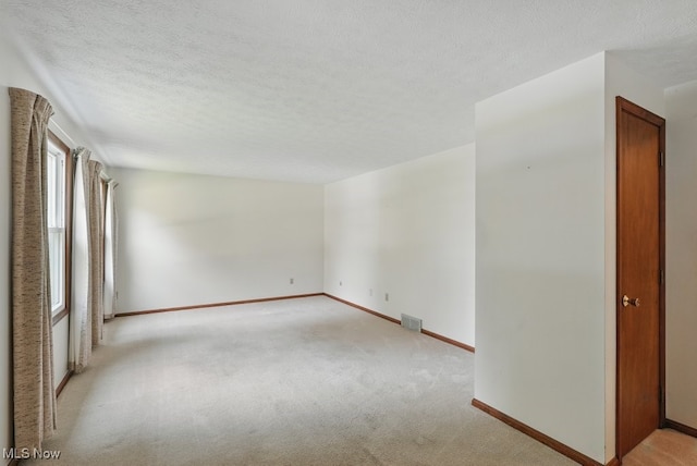 450 S Walnut St, Ravenna, OH 44266 - spare room with light colored carpet and a textured ceiling