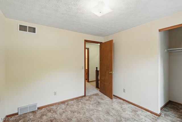 450 S Walnut St, Ravenna, OH 44266 - unfurnished bedroom with a closet, carpet flooring, and a textured ceiling