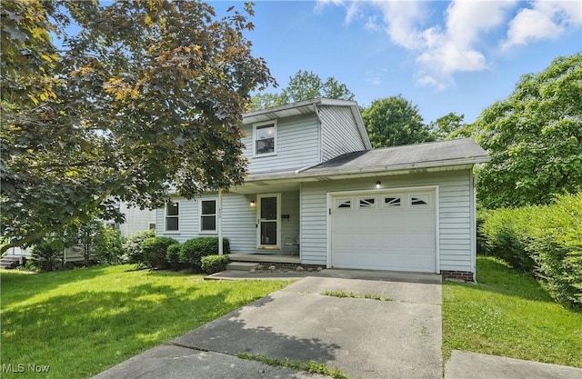 450 S Walnut St, Ravenna, OH 44266 - view of front of home with concrete driveway, a garage, and a front yard