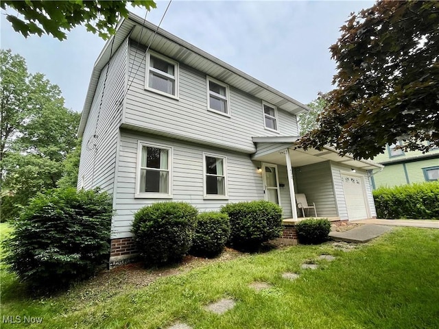 450 S Walnut St, Ravenna, OH 44266 - view of front of house featuring a garage and a front lawn