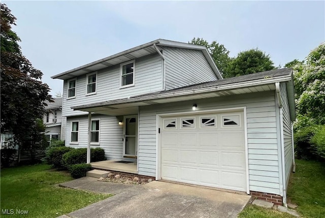 450 S Walnut St, Ravenna, OH 44266 - view of front of house with concrete driveway, a garage, and a front yard