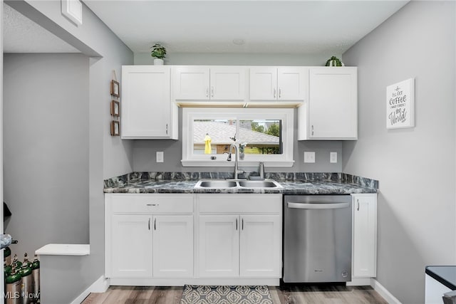 233 E 305th St, Willowick, OH 44095 - kitchen with dishwasher, dark countertops, wood finished floors, and white cabinetry