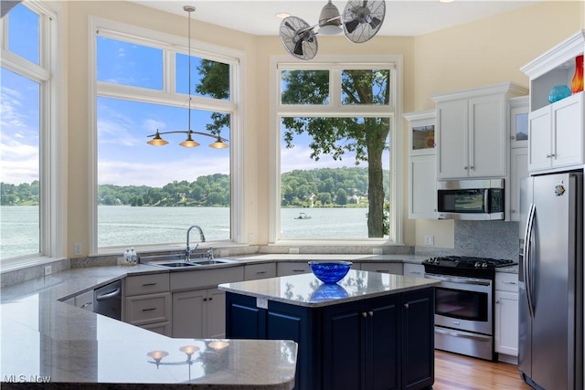 30 E Mohawk Dr, Malvern, OH 44644 - kitchen featuring stainless steel appliances, plenty of natural light, white cabinets, and light stone counters