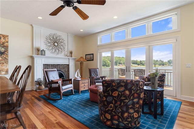 30 E Mohawk Dr, Malvern, OH 44644 - living area featuring ceiling fan, wood finished floors, a fireplace with flush hearth, recessed lighting, and french doors