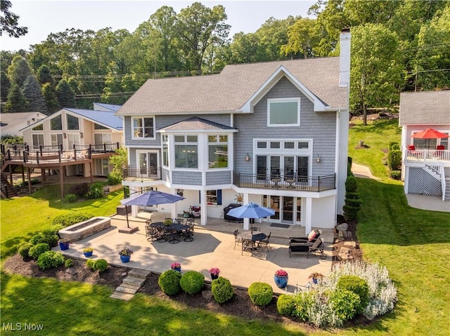 30 E Mohawk Dr, Malvern, OH 44644 - rear view of property with outdoor dining space, a patio, and a balcony