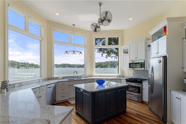 30 E Mohawk Dr, Malvern, OH 44644 - kitchen featuring appliances with stainless steel finishes, backsplash, light stone counters, hanging light fixtures, and recessed lighting