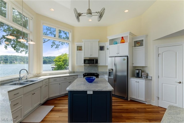 30 E Mohawk Dr, Malvern, OH 44644 - kitchen featuring appliances with stainless steel finishes, dark wood-style floors, a kitchen island, glass insert cabinets, and decorative light fixtures