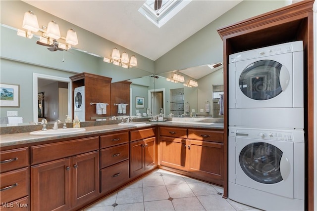 30 E Mohawk Dr, Malvern, OH 44644 - bathroom featuring stacked washing machine and dryer, lofted ceiling, a chandelier, double vanity, and tile patterned floors