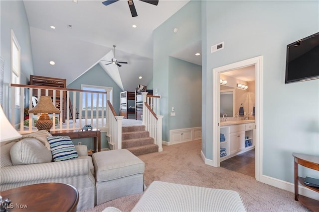30 E Mohawk Dr, Malvern, OH 44644 - living area with ceiling fan, carpet flooring, vaulted ceiling, and wainscoting