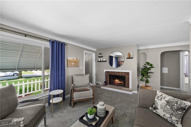 3937 W 227th St, Fairview Park, OH 44126 - carpeted living area featuring a brick fireplace and arched walkways