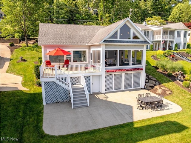 32 E Mohawk Dr, Malvern, OH 44644 - rear view of property featuring stairs, a shingled roof, a yard, and a patio area