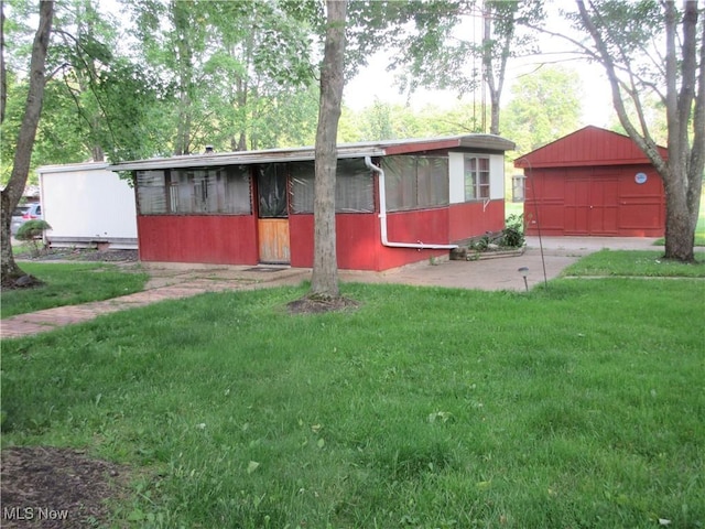 4455 Buck Run, Linesville, PA 16424 - view of front of property with a sunroom, a front lawn, and a garage