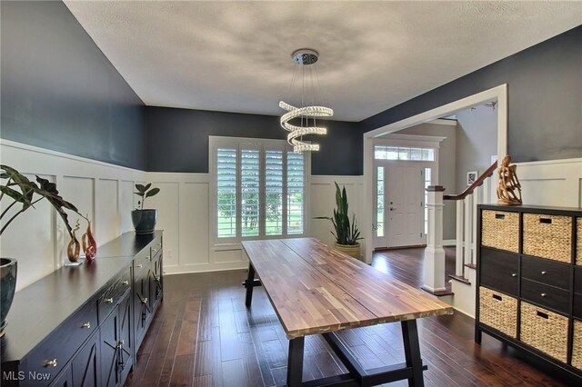3179 Merion Ct, Westlake, OH 44145 - dining space featuring a decorative wall, wainscoting, a chandelier, dark wood-style floors, and plenty of natural light