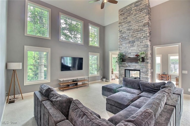 3179 Merion Ct, Westlake, OH 44145 - carpeted living room with a high ceiling, a ceiling fan, and a stone fireplace