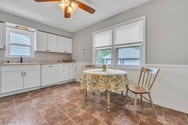 4465 W 156th St, Cleveland, OH 44135 - kitchen with white dishwasher, a wainscoted wall, light stone finish flooring, ceiling fan, and white cabinetry
