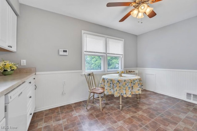 4465 W 156th St, Cleveland, OH 44135 - dining space featuring wainscoting, stone finish floors, and a ceiling fan