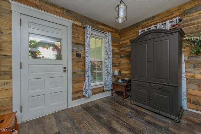 815 N Walnut St, Dover, OH 44622 - foyer entrance featuring dark wood-style floors and wooden walls