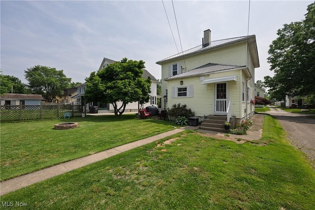 815 N Walnut St, Dover, OH 44622 - back of property with a fire pit, a chimney, and a metal roof