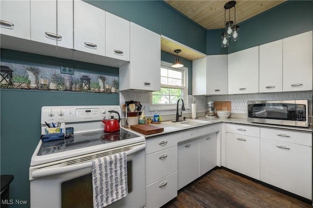 815 N Walnut St, Dover, OH 44622 - kitchen featuring white electric range oven, stainless steel microwave, dark wood finished floors, tasteful backsplash, and wood ceiling