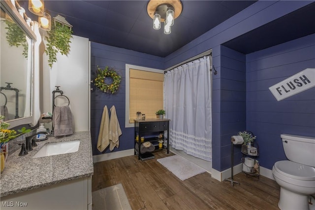 815 N Walnut St, Dover, OH 44622 - full bathroom featuring vanity, wood finished floors, wooden walls, and a shower with curtain