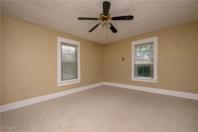815 N Walnut St, Dover, OH 44622 - carpeted empty room featuring a textured ceiling, plenty of natural light, and a ceiling fan