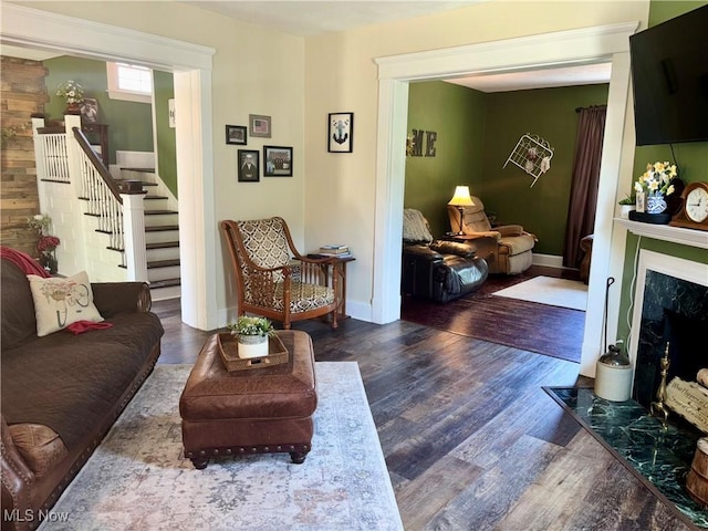 815 N Walnut St, Dover, OH 44622 - living room featuring a fireplace, stairs, and wood finished floors