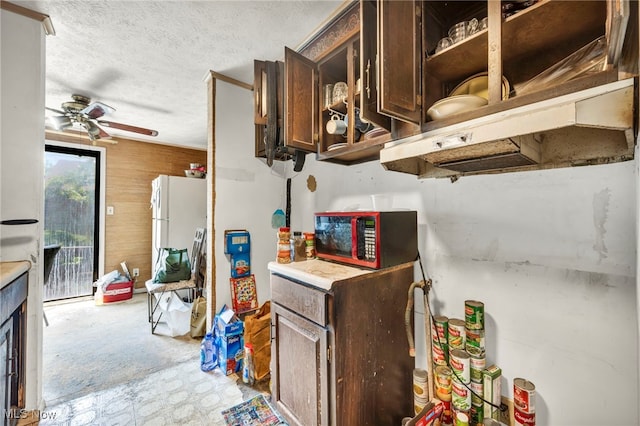 552 Turney Rd Unit A, Bedford, OH 44146 - kitchen with a ceiling fan, dark brown cabinets, freestanding refrigerator, light countertops, and a textured ceiling