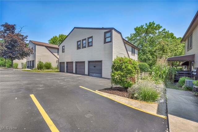 552 Turney Rd Unit A, Bedford, OH 44146 - view of home's exterior featuring a garage and asphalt driveway