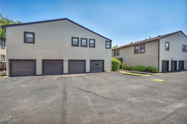 552 Turney Rd Unit A, Bedford, OH 44146 - view of side of home featuring a garage and driveway