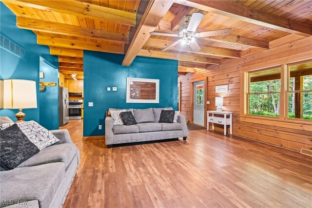15961 Terramont St NE, Minerva, OH 44657 - living area with a wooden ceiling with exposed beams, wooden walls, wood finished floors, and ceiling fan