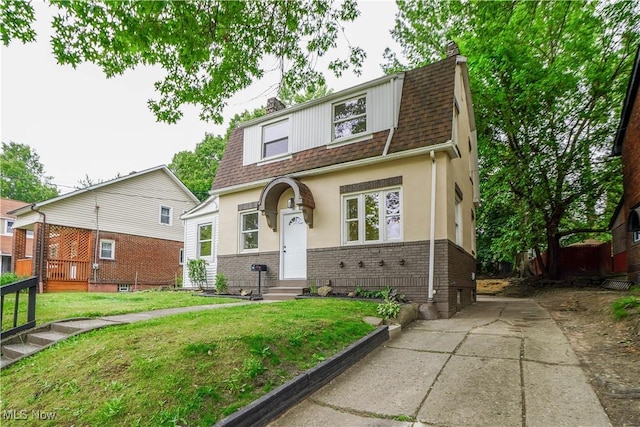 1967 Tonawanda Ave, Akron, OH 44305 - view of front of property with a chimney, roof with shingles, stucco siding, and a front yard