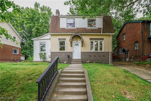 1967 Tonawanda Ave, Akron, OH 44305 - view of front of property with a shingled roof, a chimney, a front lawn, and brick siding