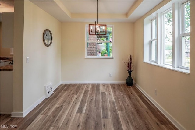 1967 Tonawanda Ave, Akron, OH 44305 - unfurnished dining area featuring a raised ceiling, plenty of natural light, and wood finished floors