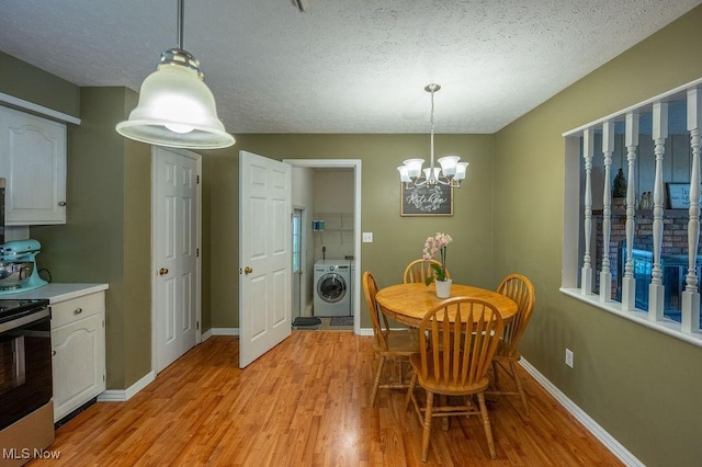 106 Wedgewood Dr, Parkersburg, WV 26104 - dining area with washer / clothes dryer, light wood-style flooring, a textured ceiling, and a chandelier