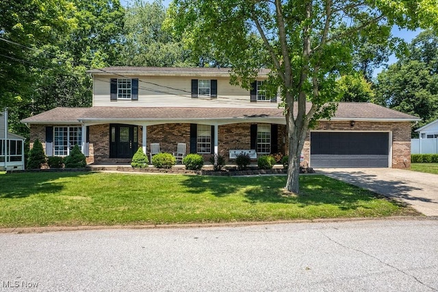 106 Wedgewood Dr, Parkersburg, WV 26104 - traditional home with concrete driveway, an attached garage, a front yard, brick siding, and a porch