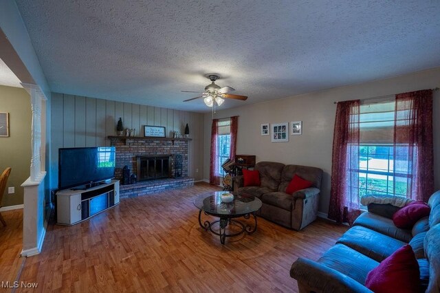 106 Wedgewood Dr, Parkersburg, WV 26104 - living area with a textured ceiling, wood finished floors, a ceiling fan, and a fireplace