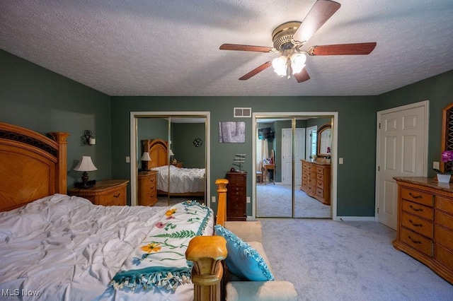 106 Wedgewood Dr, Parkersburg, WV 26104 - bedroom featuring multiple closets, a textured ceiling, light colored carpet, and ceiling fan