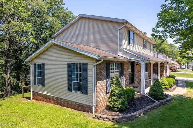 106 Wedgewood Dr, Parkersburg, WV 26104 - view of property exterior with a lawn, covered porch, a chimney, and brick siding