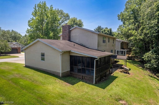 106 Wedgewood Dr, Parkersburg, WV 26104 - view of home's exterior featuring a sunroom, a chimney, roof with shingles, and a lawn