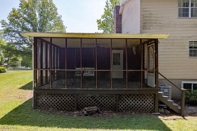 106 Wedgewood Dr, Parkersburg, WV 26104 - back of house featuring a sunroom, a lawn, and a chimney