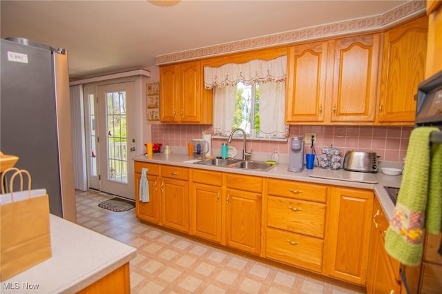 104 W Blvd, Mingo Junction, OH 43938 - kitchen with freestanding refrigerator, light floors, light countertops, decorative backsplash, and brown cabinets