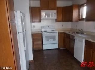 812 W W, Elyria, OH 44035 - kitchen featuring white appliances, brown cabinetry, and light countertops