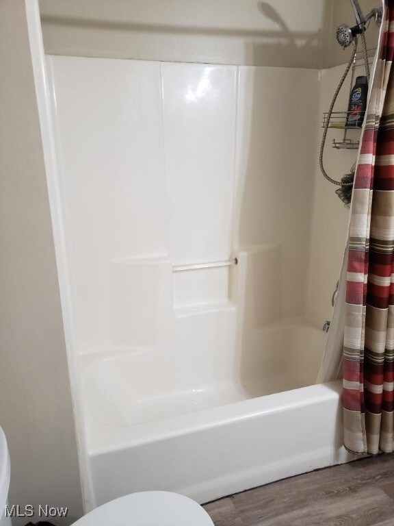 812 W W, Elyria, OH 44035 - full bathroom with wood finished floors and shower / bathtub combination with curtain