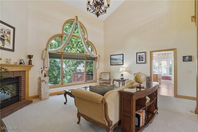 1288 Windward Ln, Kent, OH 44240 - living area featuring carpet floors, high vaulted ceiling, a brick fireplace, and a chandelier