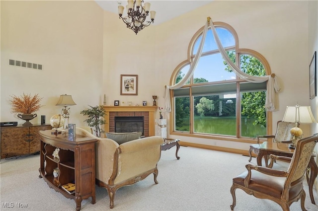1288 Windward Ln, Kent, OH 44240 - carpeted living area with a high ceiling, a brick fireplace, and a chandelier