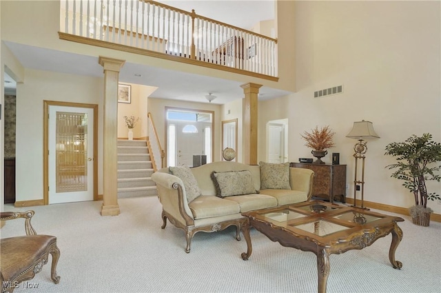 1288 Windward Ln, Kent, OH 44240 - living area featuring ornate columns, carpet, stairway, and a high ceiling